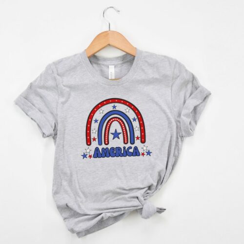 Bella + Canvas 3001 unisex T-shirt in athletic heather with a fun and vibrant red, white, and blue rainbow and “America” written in a retro font