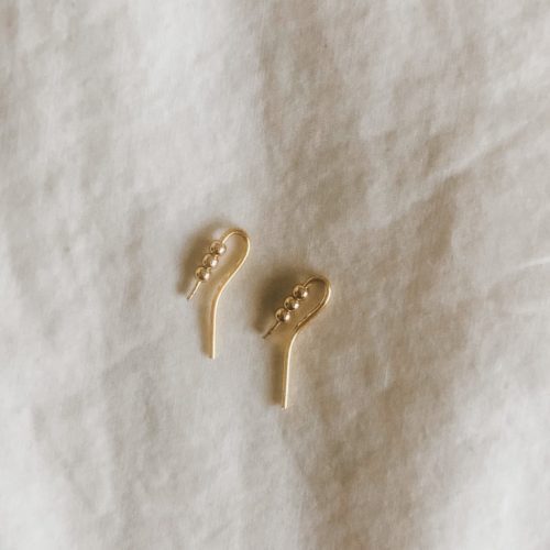three gold bead earring on white background