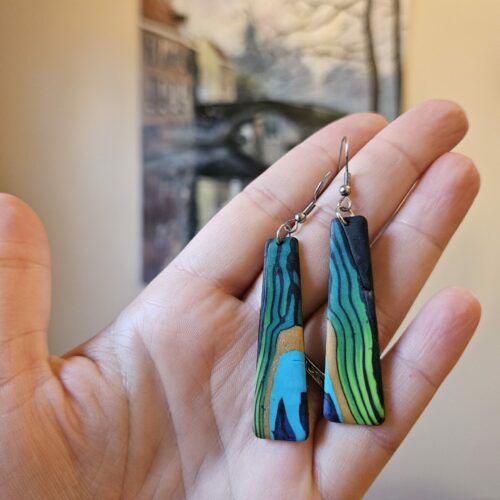 Tapered earring pair with a single peacock feather pattern across two earrings