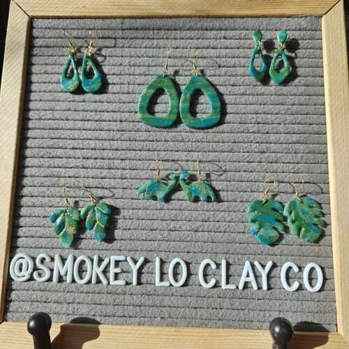 A variety of styles of green earrings