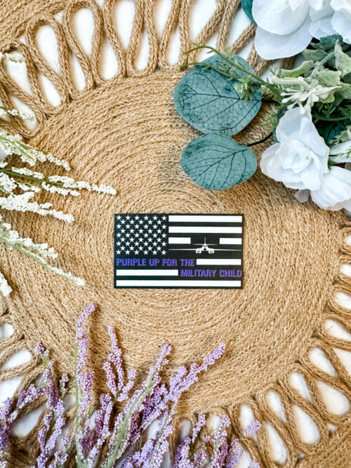Black and White US Flag sticker featuring a B-1 Bomber and the saying, “Purple up for the military child”