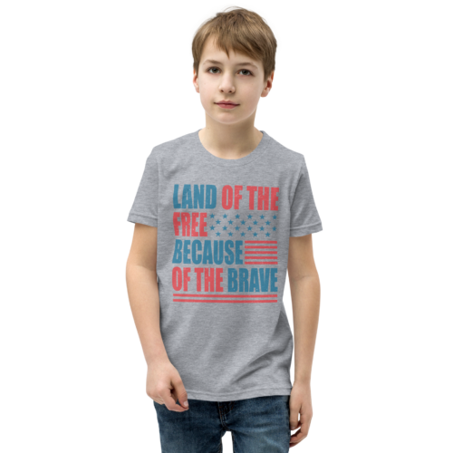 Youth T-Shirt in grey with “Land of the free, because of the brave” written on it in a red and blue muted color scheme