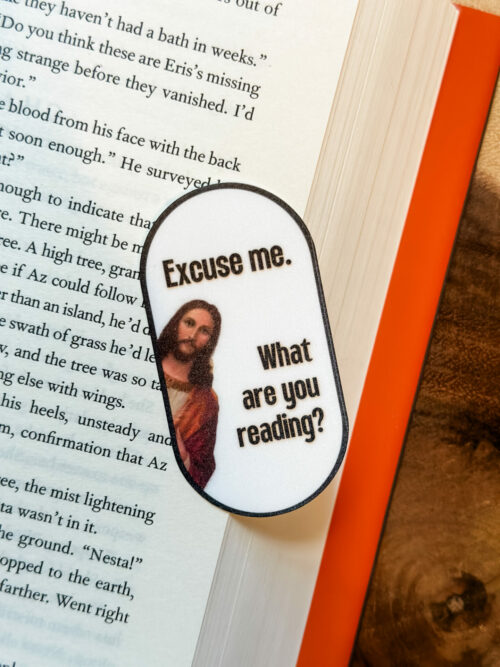 Oval sticker with Jesus in on the side asking, “Excuse me, what are you reading?”