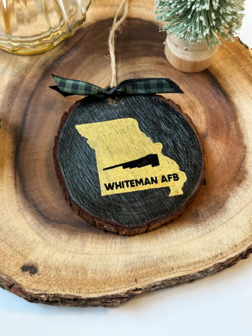 Hand painted wood slice ornament for Whiteman AFB with state of Missouri silhouette and B-2 Spirit Bomber
