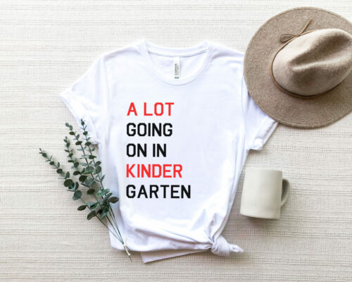 Bella Canvas 3001 unisex adult white T-shirt with saying, “A lot going on in Kindergarten.” Show off your Swiftie Love