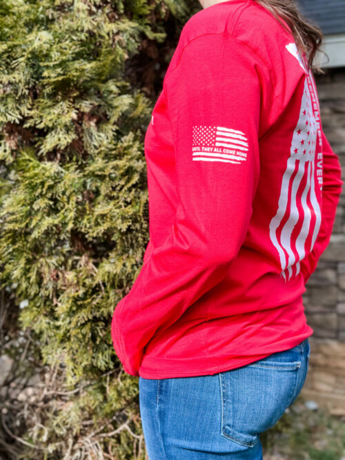 Bella Canvas 3501 long sleeve in red with left sleeve flag saying “until they all come home”