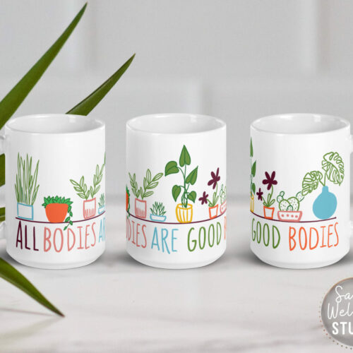 Body positive mug- 15oz ceramic mug with colorful hand-drawn plants wrapping around and hand-lettering "ALL BODIES ARE GOOD BODIES"