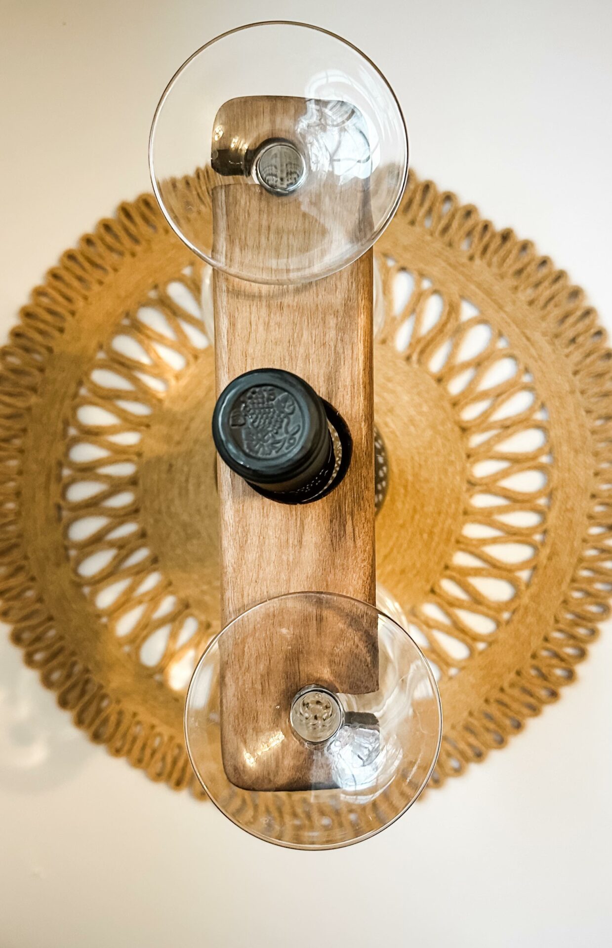 Wine bottle displaying a walnut wine glass caddy.